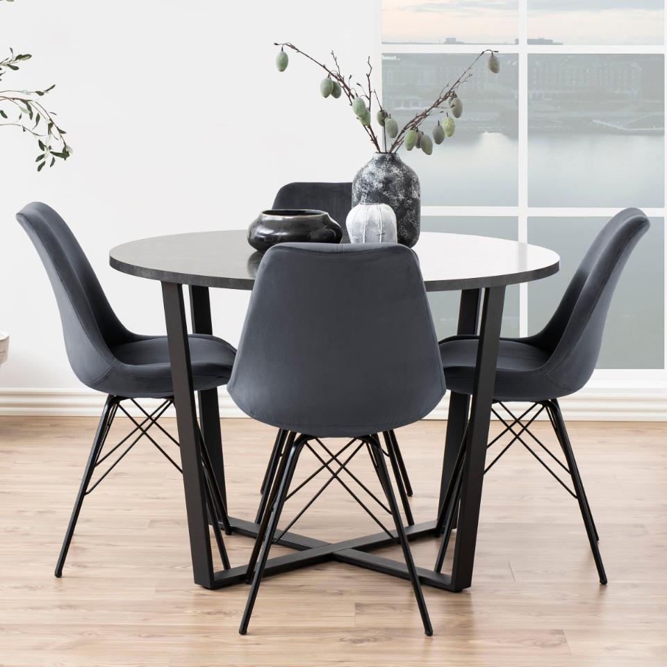 An Amble black dining table with 4 chairs in a modern room