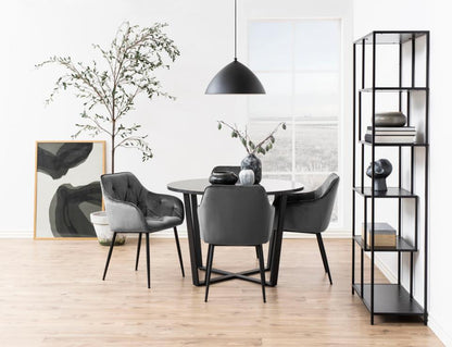 Round amble dining table with chairs and storage unit in a modern room