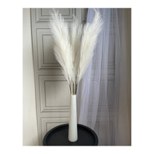Load image into Gallery viewer, 3 stems of artificial pampas grass in a white cylinder glass vase on a lamp table by Homestreet
