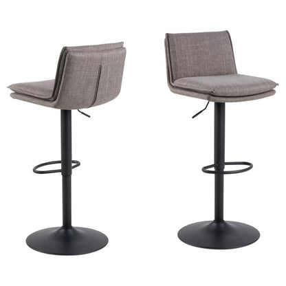 Two bar stools with upholstered seats in light grey fabric and black metal legs, featuring a classic silhouette with French stitching details.