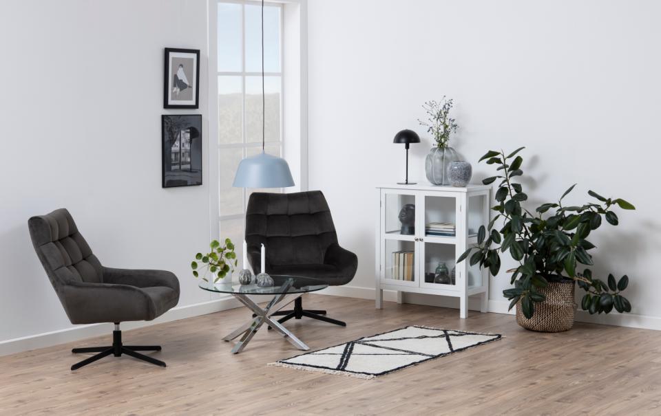 heaven clear glass coffee table in a modern home with 2 chairs, a plant and white bookcase unit