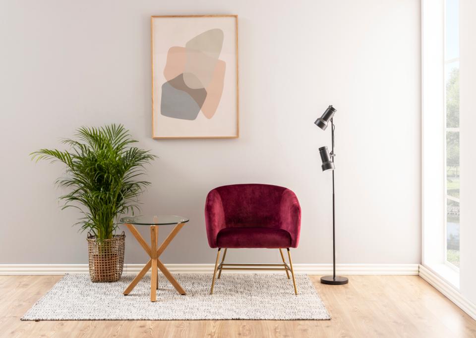 heaven side table in a roomset with a red chair and plant