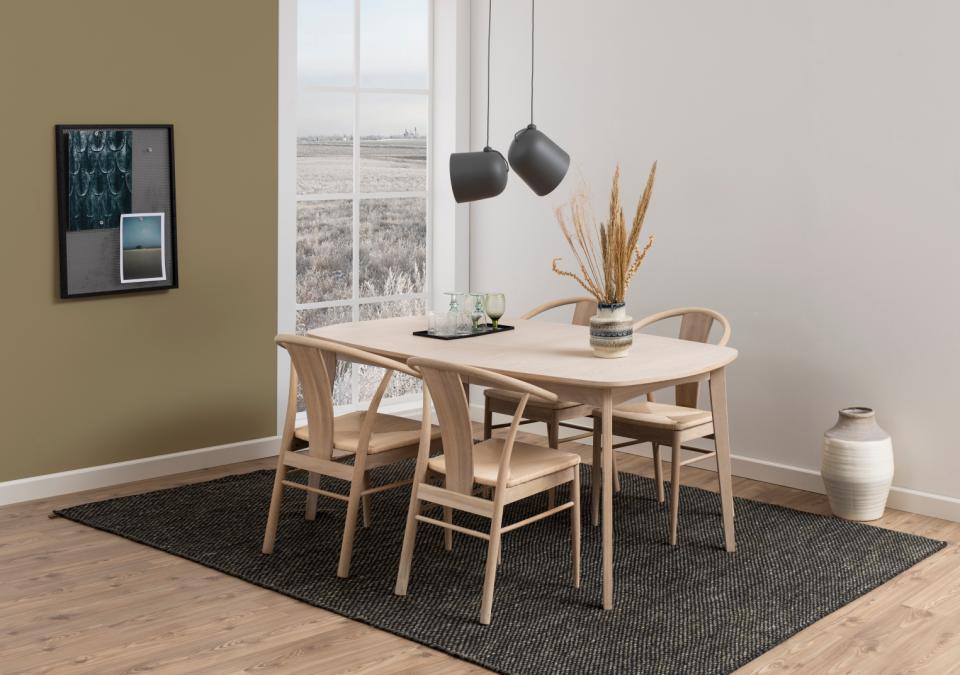 4 cream paer plaited janik dining chairs in a modern  room with an oval dining table