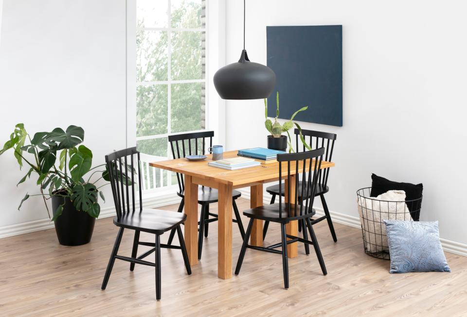 kenley oak dining table by homestreet in a odern dining room with black oak chairs