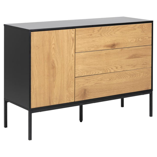 A Seaford Oak Sideboard featuring a black frame with one door and three drawers in a oak finish, placed on metal legs.